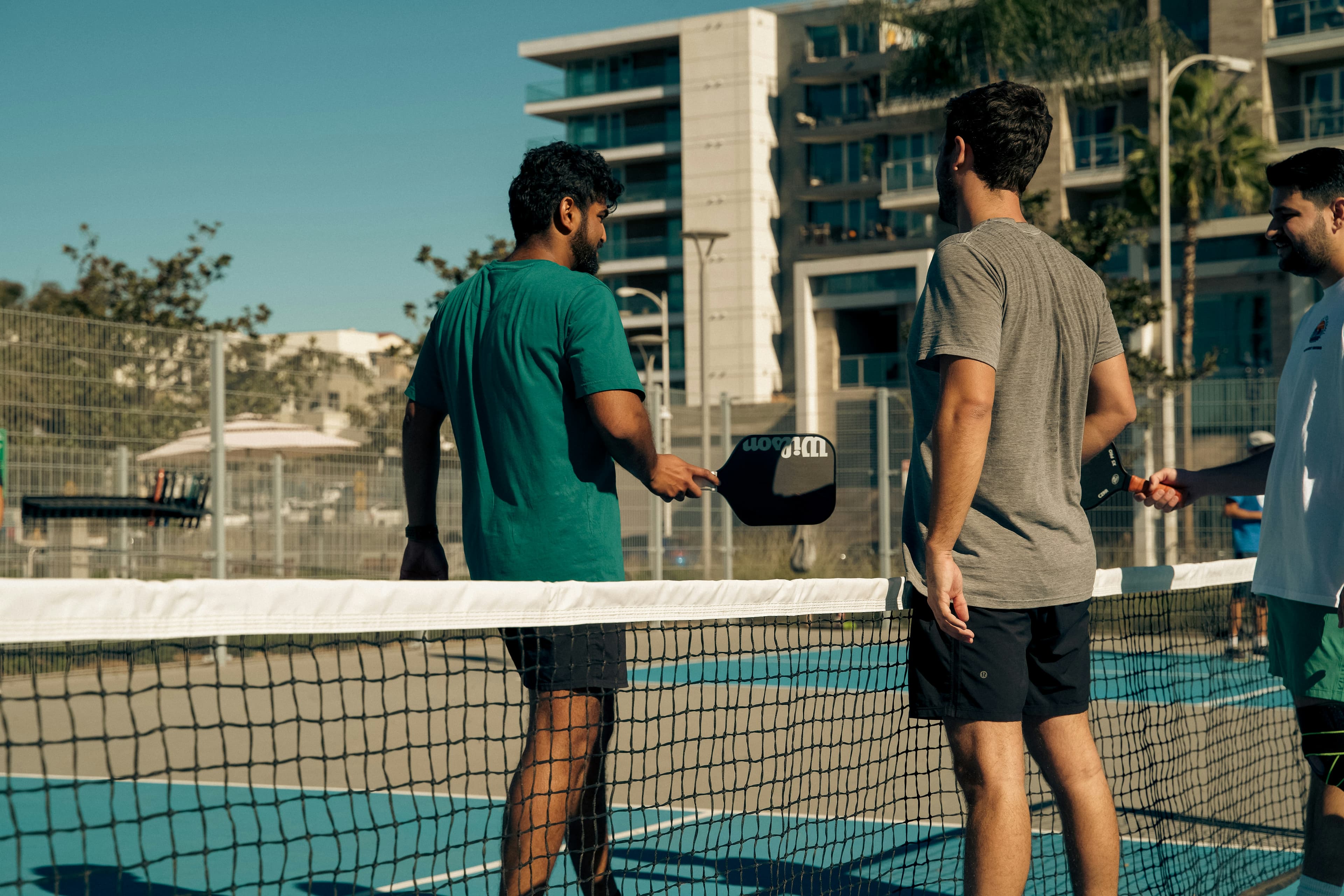 Players meeting across the pickleball net