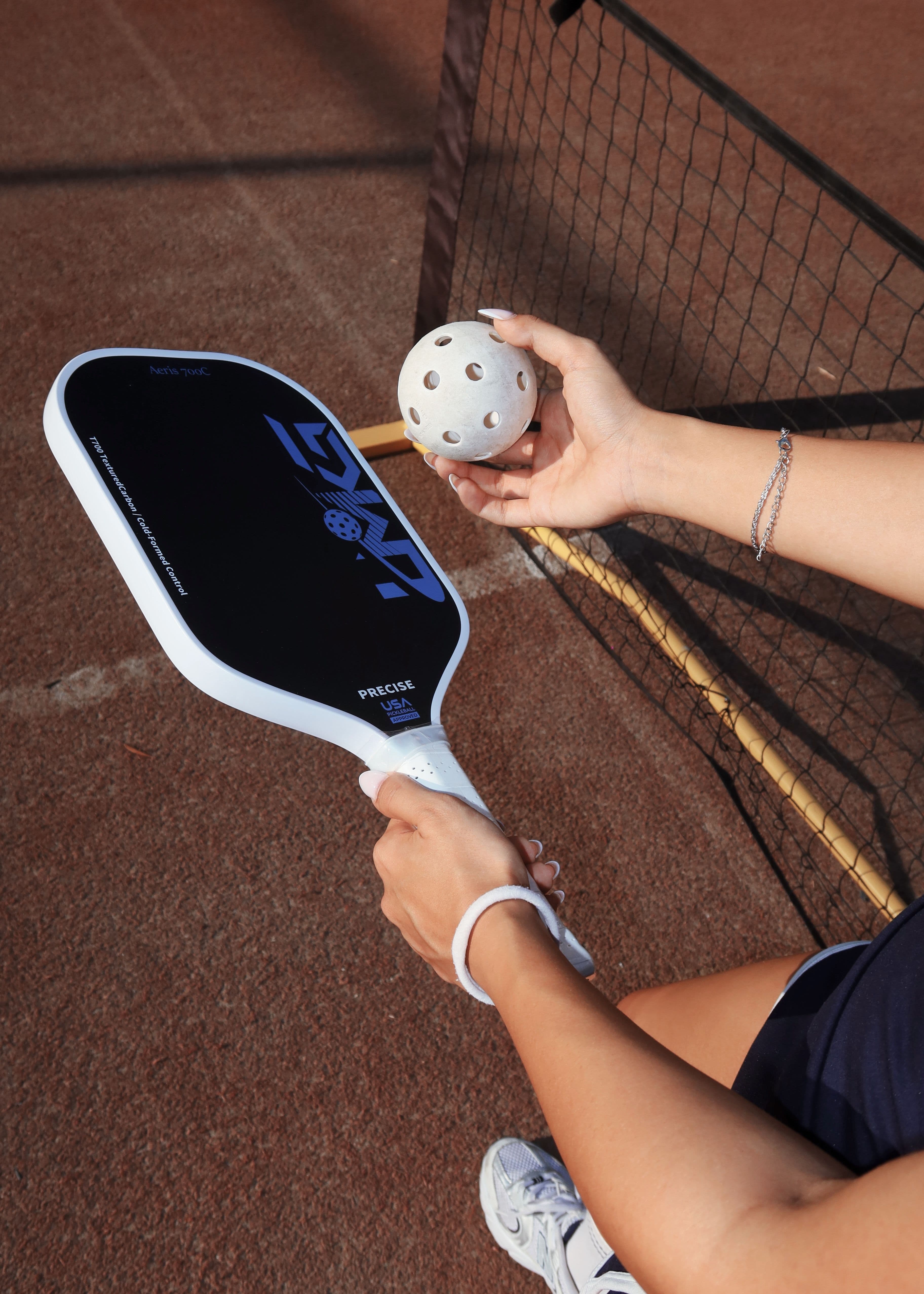 A pickleball paddle and ball